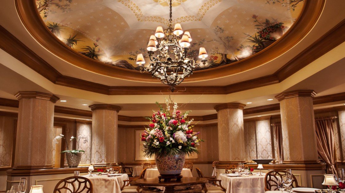 dining room with large chandelier and victorian decor